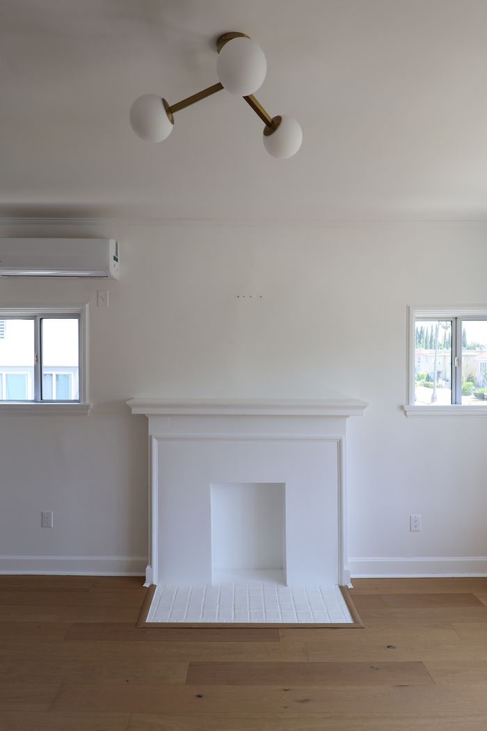 Restored fireplace and mantel in a finished home remodel