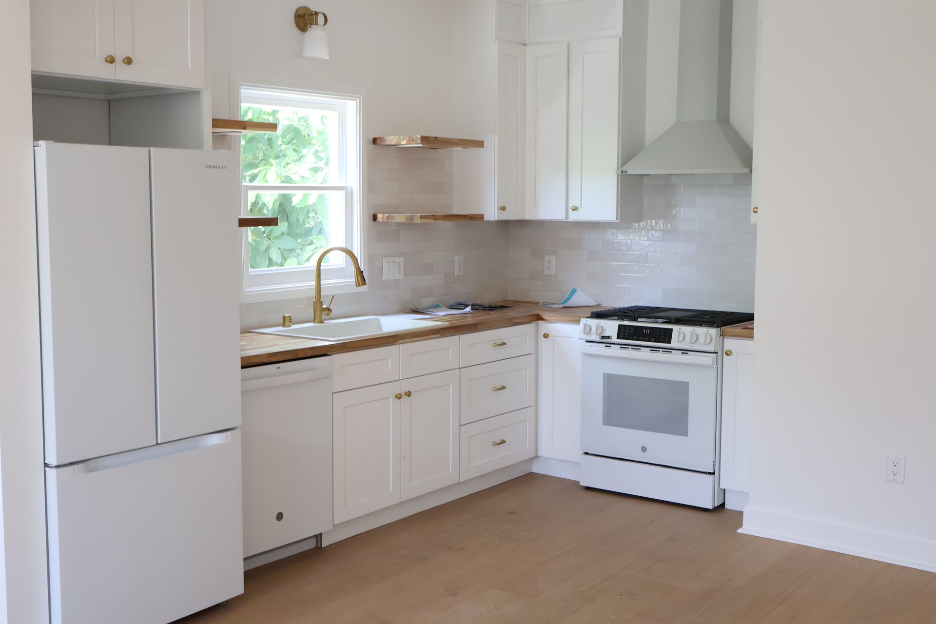 Fully remodeled kitchen with white shaker cabinets, brass fixtures and butcher block counters — Guillen Construction, Los Angeles